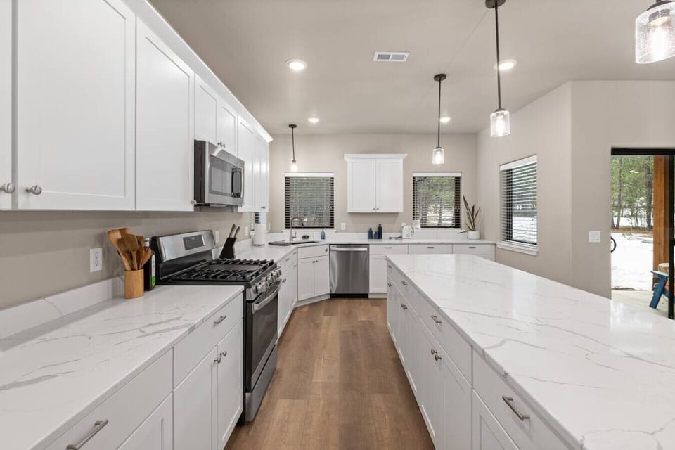 Share meals around a warm wooden table under elegant pendant lighting, with an open-concept layout that keeps everyone connected.