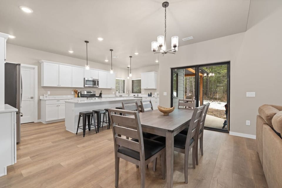 Cook with ease in a modern space featuring stainless steel appliances, marble countertops, and a spacious island perfect for gatherings.