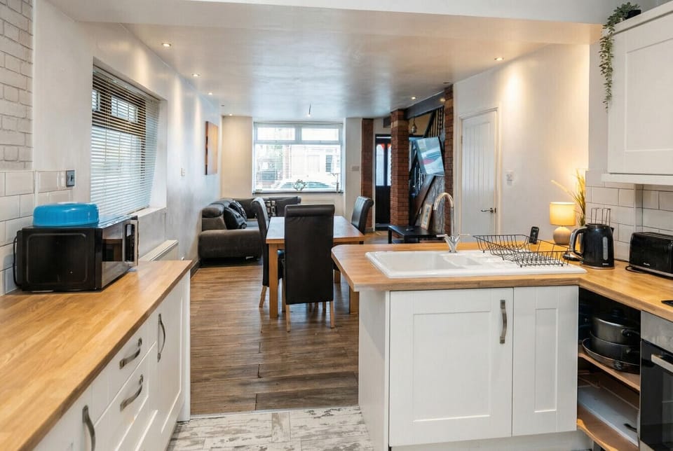 The bright kitchen connects seamlessly to dining and living for easy group meals.