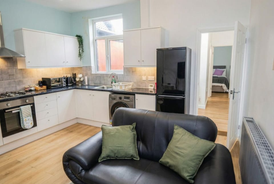 From the sofa you look straight through to the kitchen and the second bedroom beyond.
