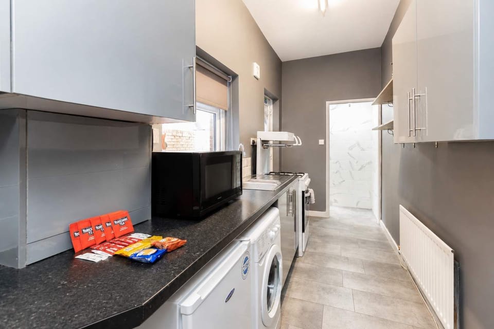 Modern, equipped kitchen with sleek finishes, ample workspace, and everything you need for a comfortable short or extended stay
