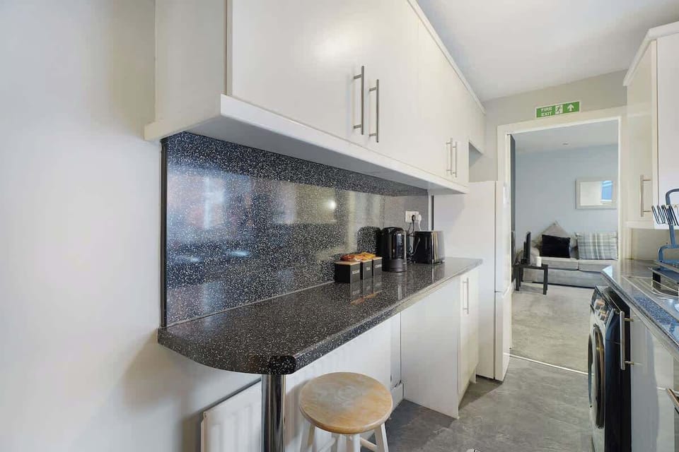 Fully equipped kitchen with everything you need for home-cooked meals, including modern appliances and ample worktop space.