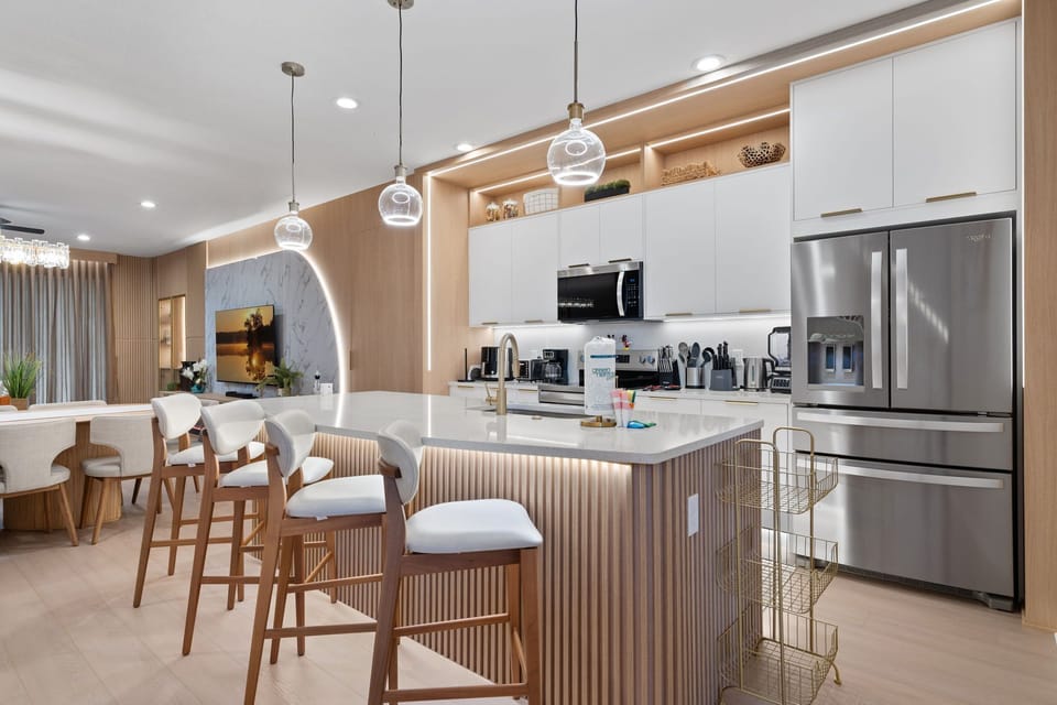 Modern fully equipped kitchen with spacious island and seating.