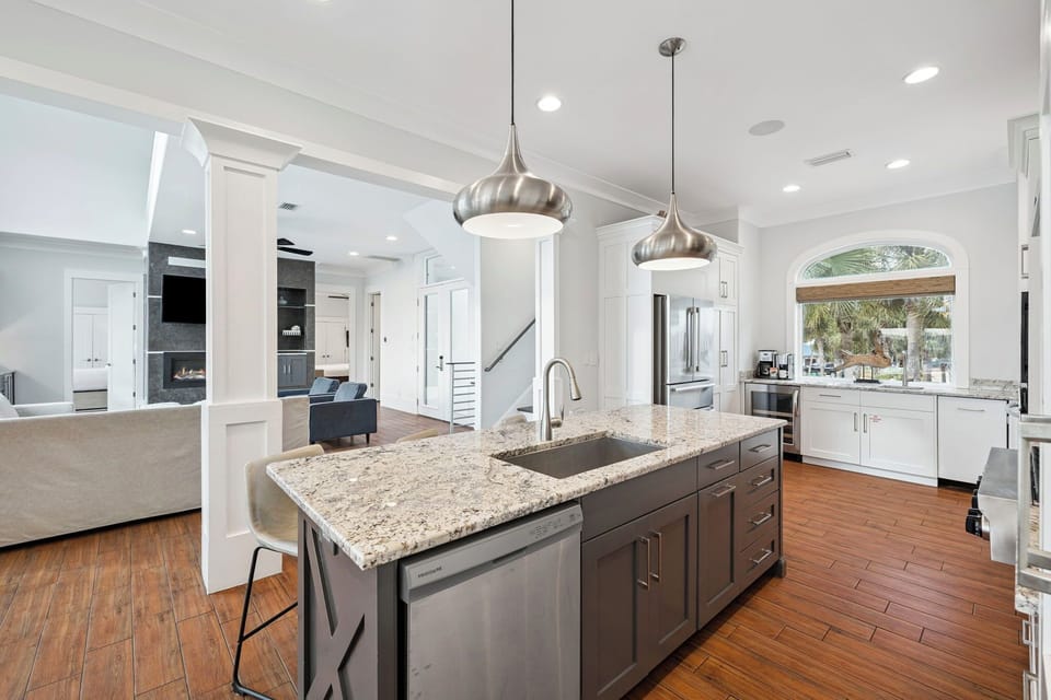 You'll love preparing meals in this stunning gourmet kitchen featuring granite countertops, modern appliances, and elegant pendant lighting.