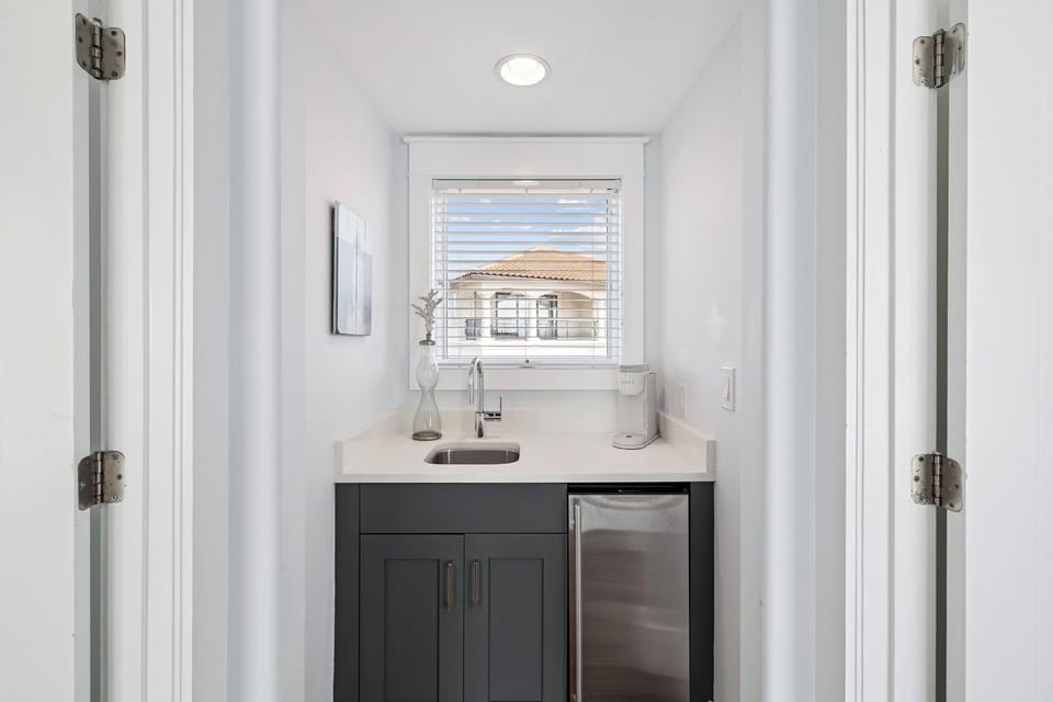 Your private kitchenette features sleek countertops and modern appliances, perfect for preparing light meals while enjoying peaceful neighborhood views.