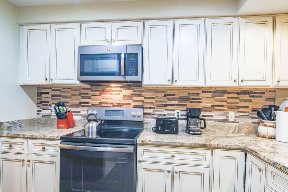 The kitchen also has an electric range, microwave, toaster and drip coffee maker.