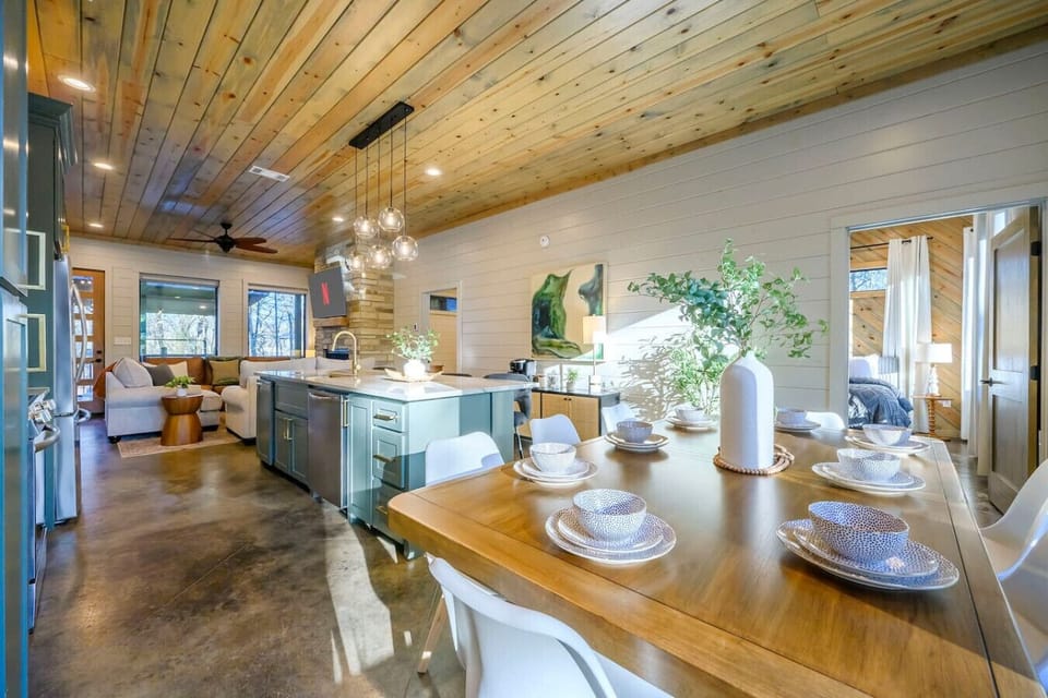 This open-concept space flows seamlessly from the dining table through the kitchen to the living area with gorgeous wood ceilings and tons of natural light.