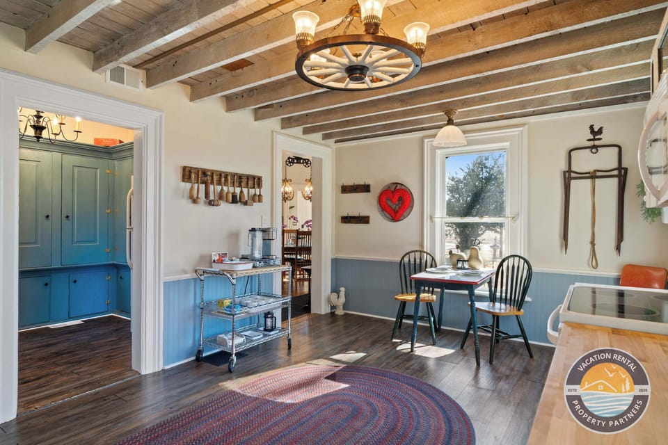 Charming farmhouse kitchen with exposed beams and custom cabinetry. Fully equipped for large group meals, holiday gatherings, and extended stays near Lake Geneva and Kettle Moraine State Forest.
