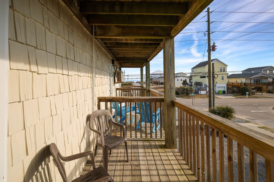 Private covered balcony with seating — enjoy morning coffee or evening breezes.