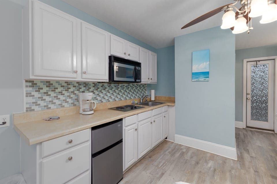 Convenient kitchenette setup with essentials for quick snacks and morning coffee