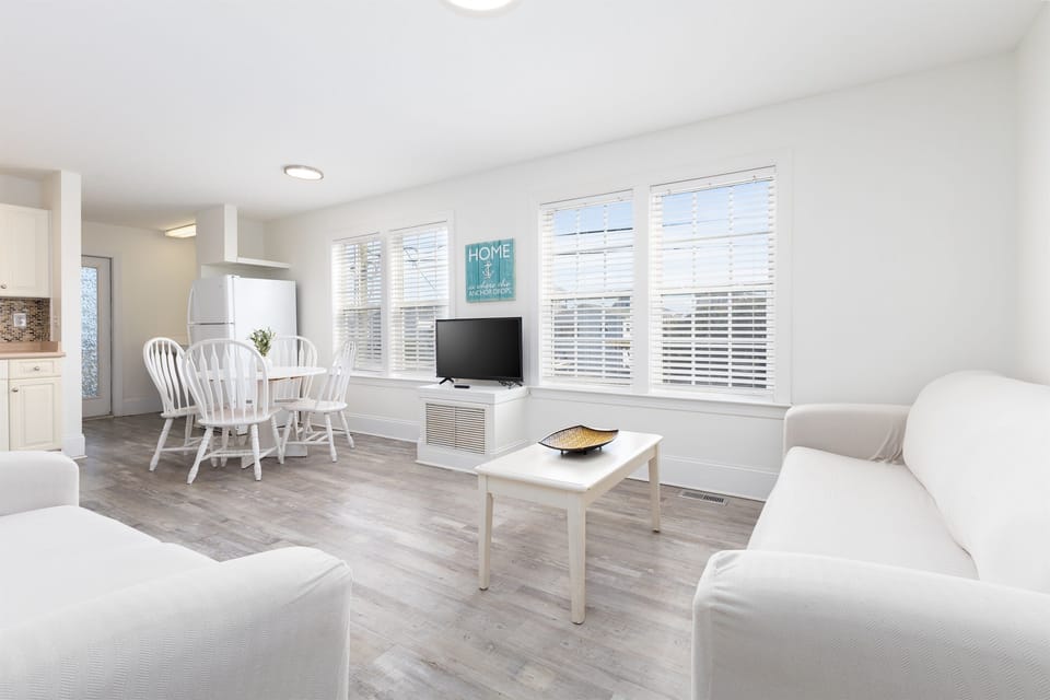Open, airy living and dining space with coastal charm! Bright mornings and relaxed evenings await