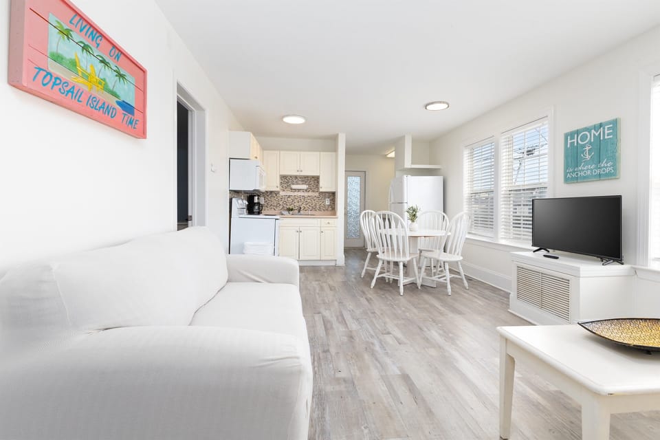 Bright coastal living with an open layout—kick back on the sofa, cook with ease, and dine together just steps away
