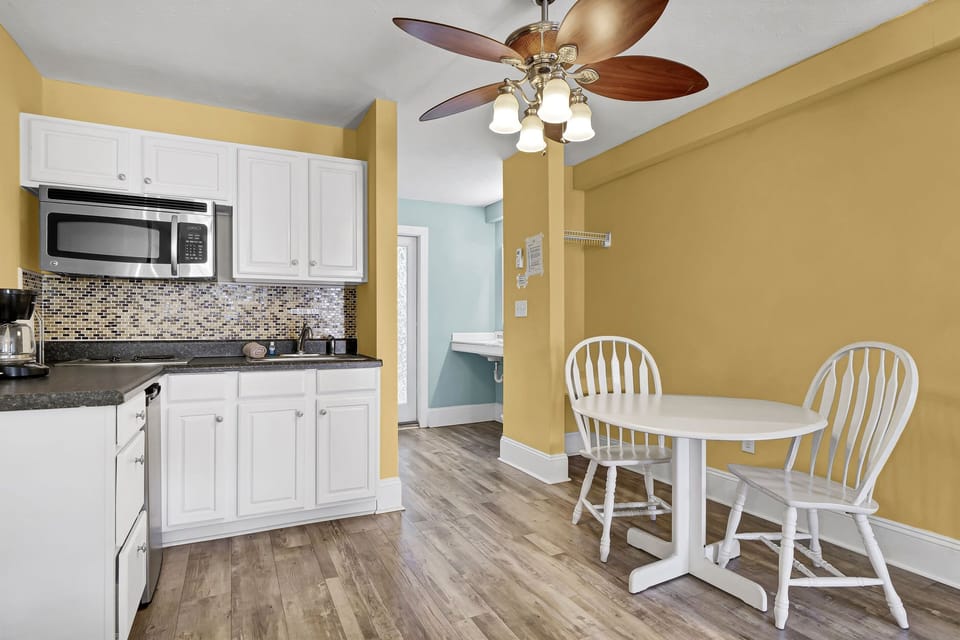 Convenient kitchenette with essential appliances and a cozy dining nook, ideal for morning coffee, light meals, or a relaxed evening in 