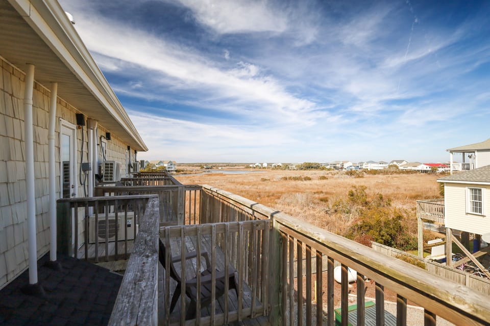 Private balcony overlooking peaceful marsh views—perfect for morning coffee or quiet moments