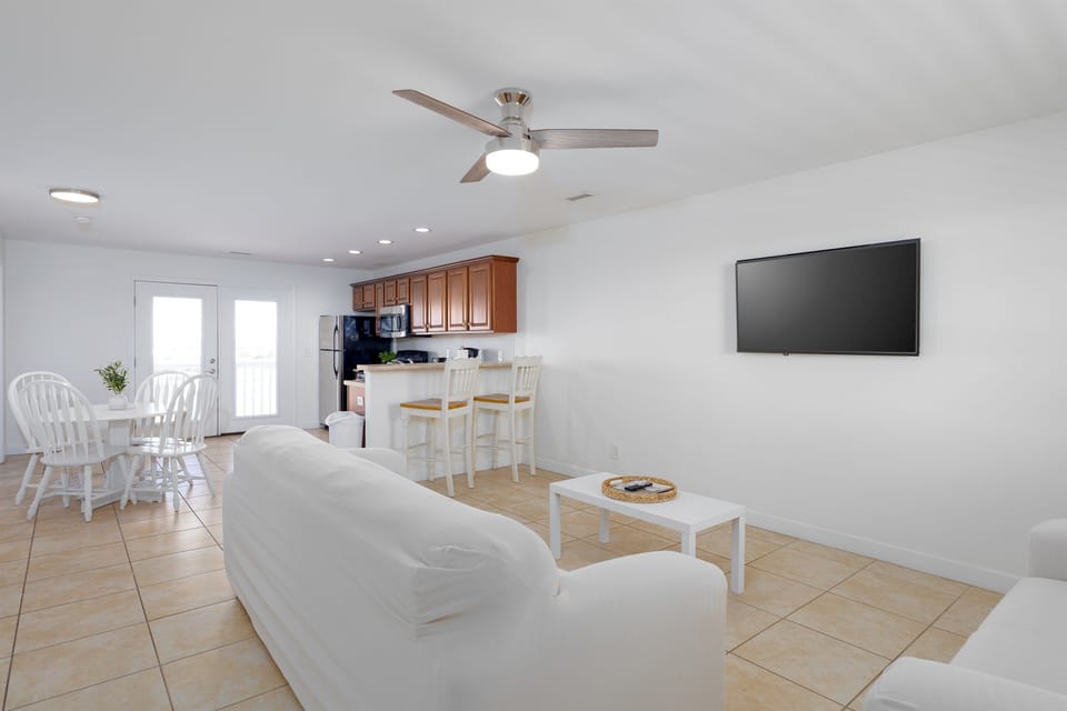 Open-concept living area with comfortable seating, bar seating, and plenty of natural light for easy gathering and relaxing