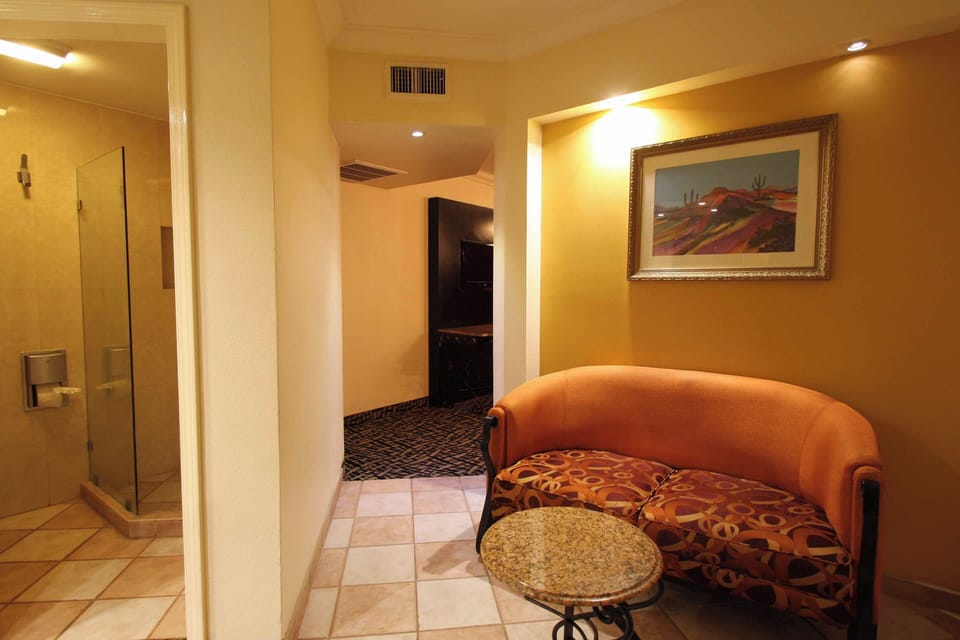 Deluxe Room | Living area | 55-inch Smart TV with cable channels