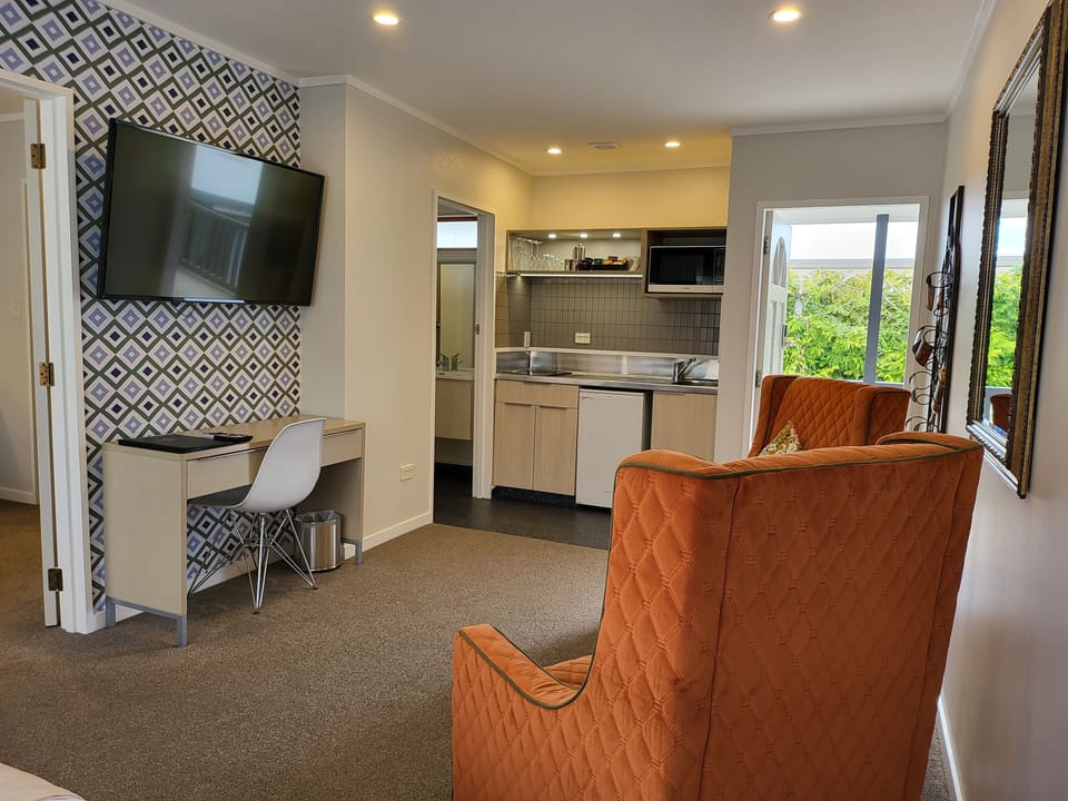 Premium One Bedroom | Living area | 50-inch flat-screen TV with cable channels, TV, Netflix
