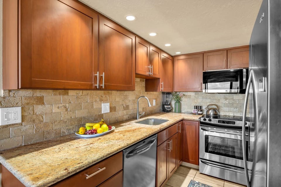 Warm wood cabinetry, sleek appliances, and plenty of counter space make this kitchen both stylish and functional