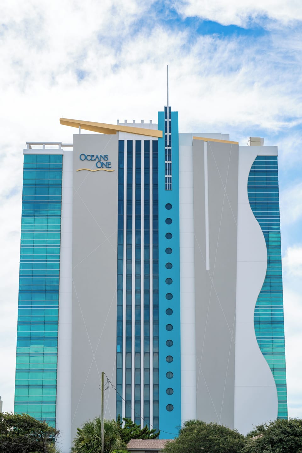 Modern high-rise building with sleek glass architecture, reflecting the vibrant 