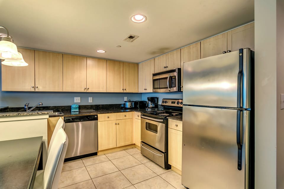 elegant flooring, sleek furniture, and stainless steel appliances.