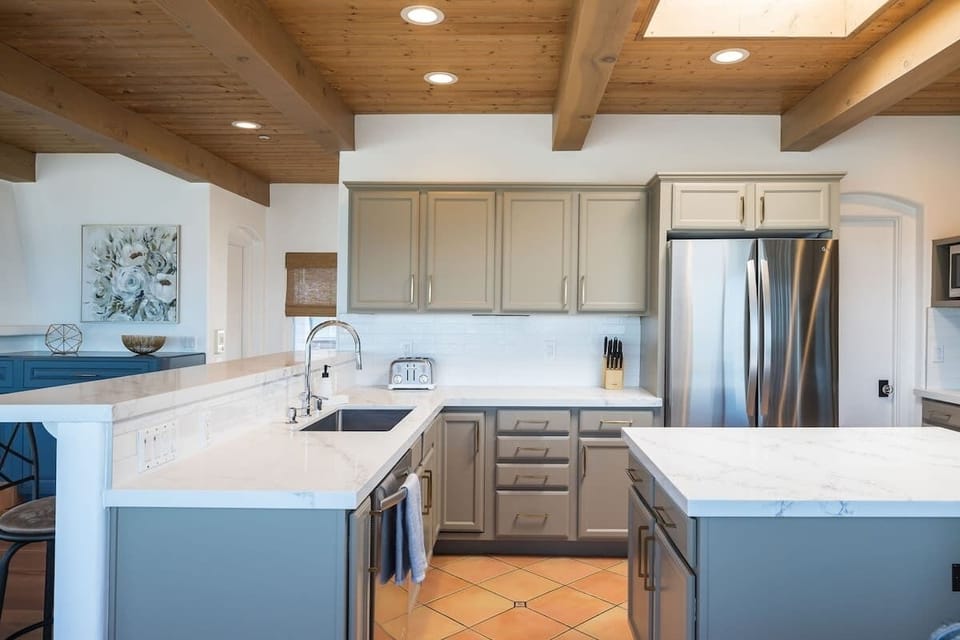 Fully equipped kitchen with a central island, stainless steel appliances, and plenty of space for cooking and gathering.