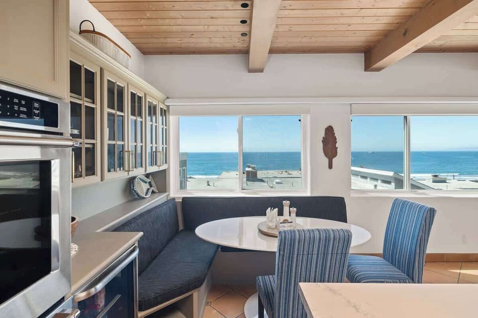Built-in breakfast nook with ocean views through large windows, perfect for slow mornings and casual meals.