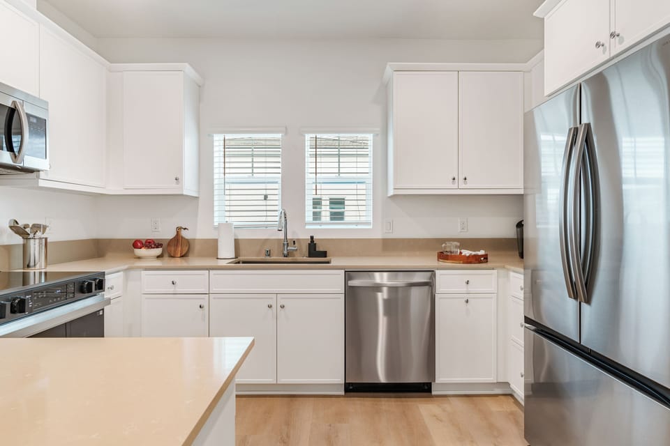 A gourmet kitchen featuring sleek shaker-style cabinetry and stainless steel appliances