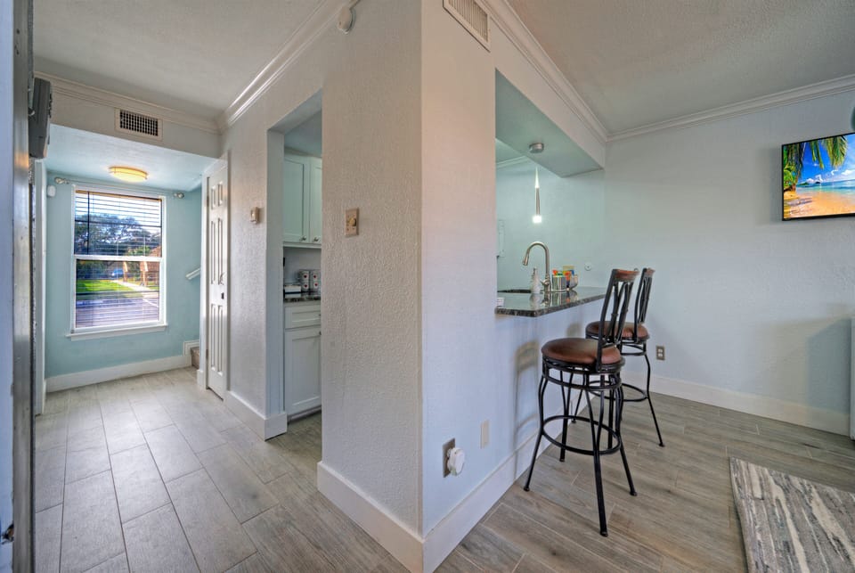 Hallway view showing the breakfast bar and high-back seating.