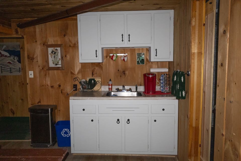 The small downstairs kitchenette provides an additional sink and Keurig coffee maker.