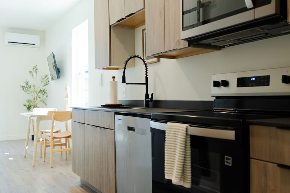 Your sleek kitchen features modern appliances and a stylish black faucet, perfect for preparing meals during your stay.