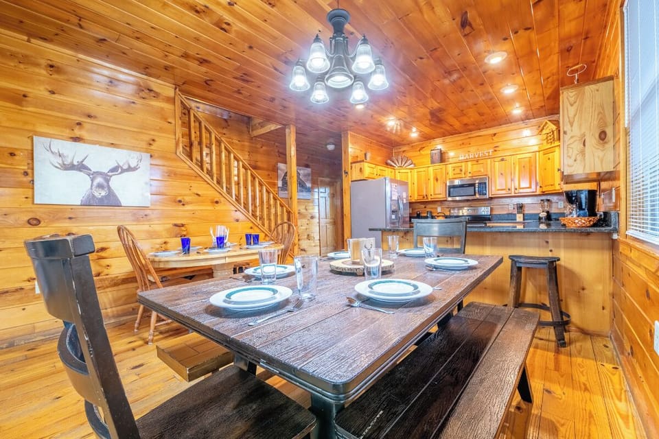 Gather around your rustic dining table where warm wood surrounds you and memories are made over home-cooked meals in this cozy cabin retreat.