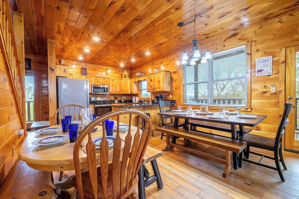Gather around the rustic dining table where your group can share memorable meals beneath warm wood beams and twinkling lights.