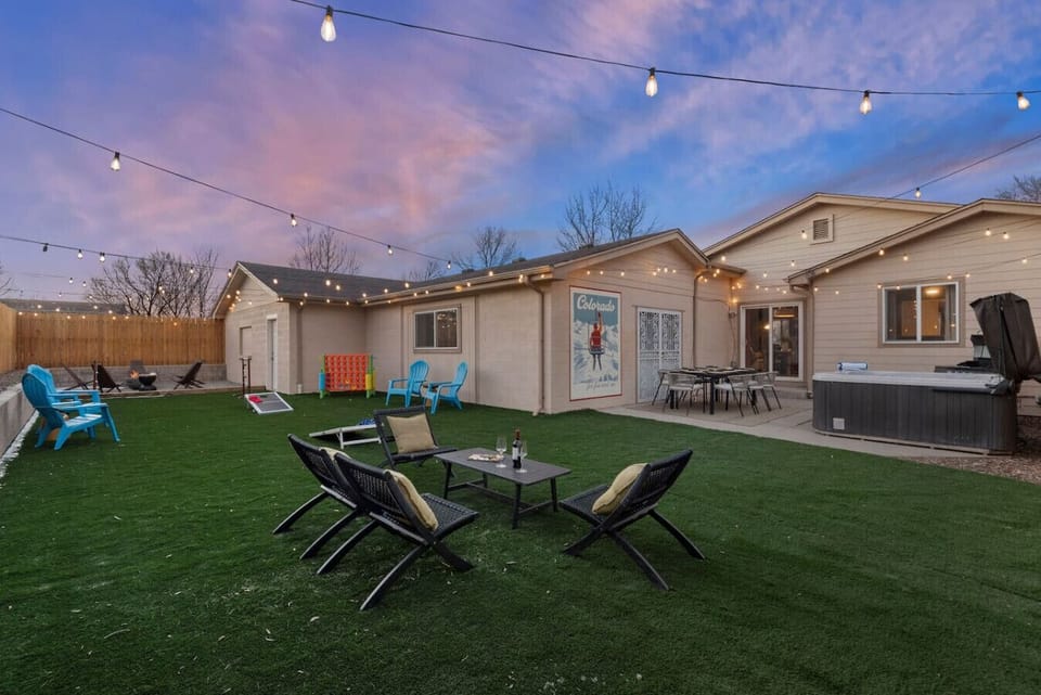 Fully fenced backyard with turf, yard games, and space for the whole group to unwind