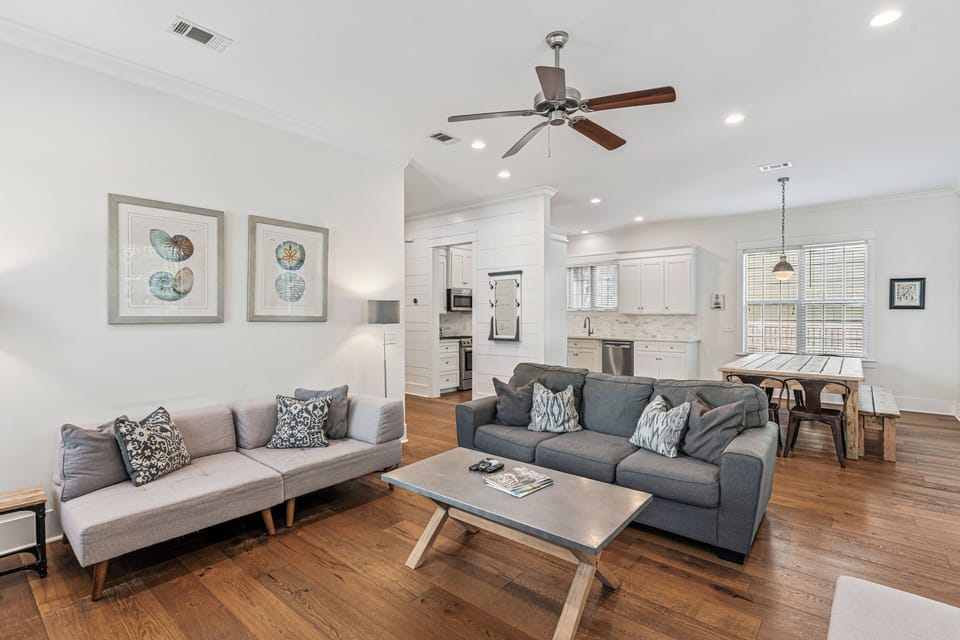 Relax in your spacious open-plan living area with modern furnishings, gleaming hardwood floors, and a gourmet kitchen perfect for home-cooked meals.