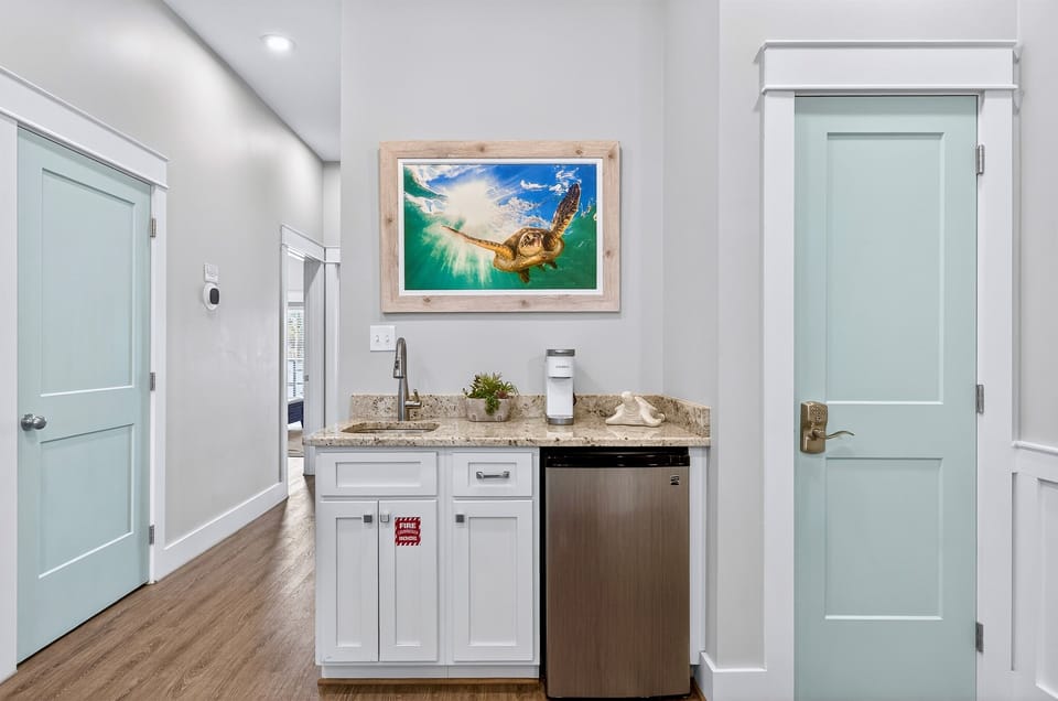 2nd Floor - Lounge area with comfortable seating and Smart TV, plus a built-in wet bar featuring a coffee maker, mini fridge, and sink—perfect for morning coffee, evening drinks, or a private upstairs retreat.