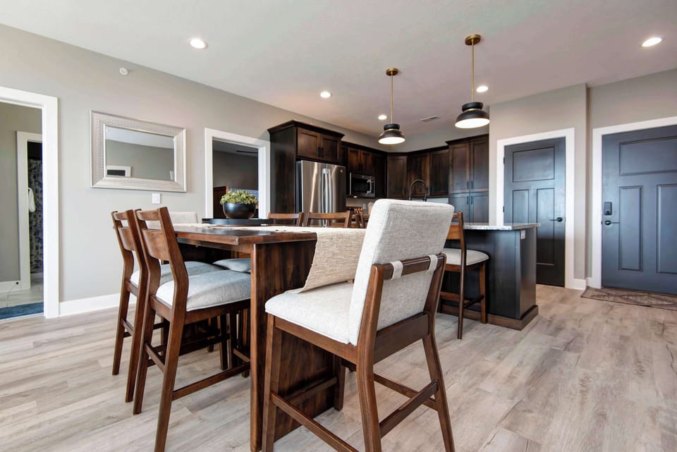 Spacious dining table with comfortable seating for 6 guests, ideal for family meals, group dining, holiday gatherings, and memorable vacation dinners.
