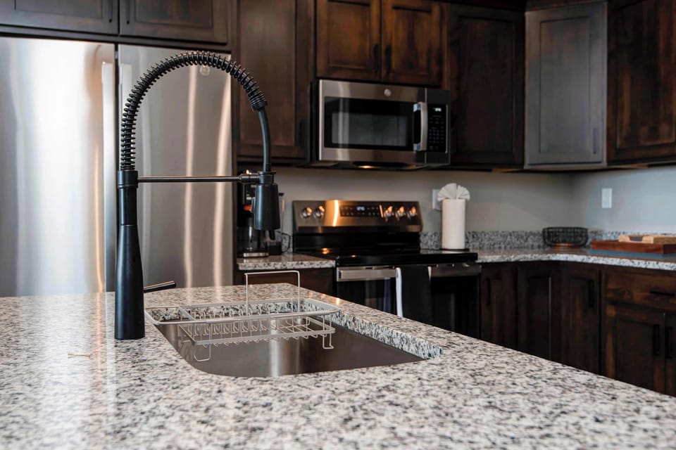 Kitchen sink conveniently located at the breakfast bar, creating an open-concept space perfect for cooking, entertaining, and spending time with family and friends.