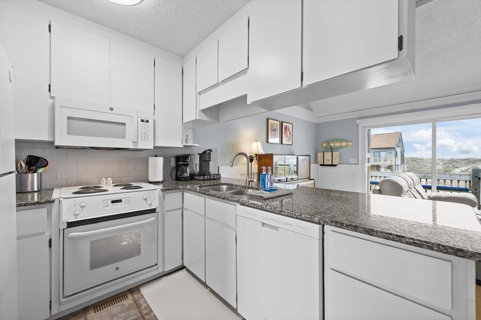 Bright, well-equipped kitchen with granite counters—easy meals, quick snacks, and everything within reach