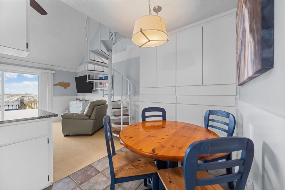 Cozy dining nook with spiral-staircase charm