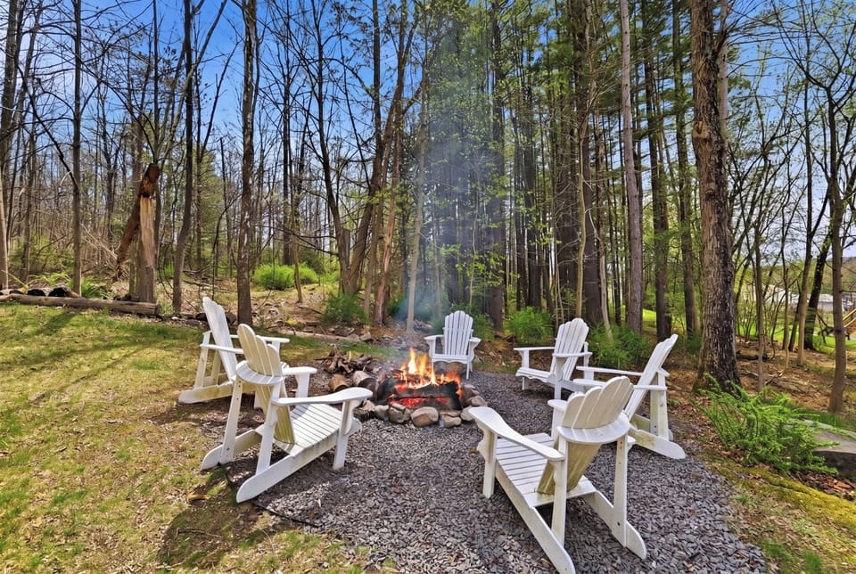 Cozy fire pit area surrounded by trees. Perfect for evening.