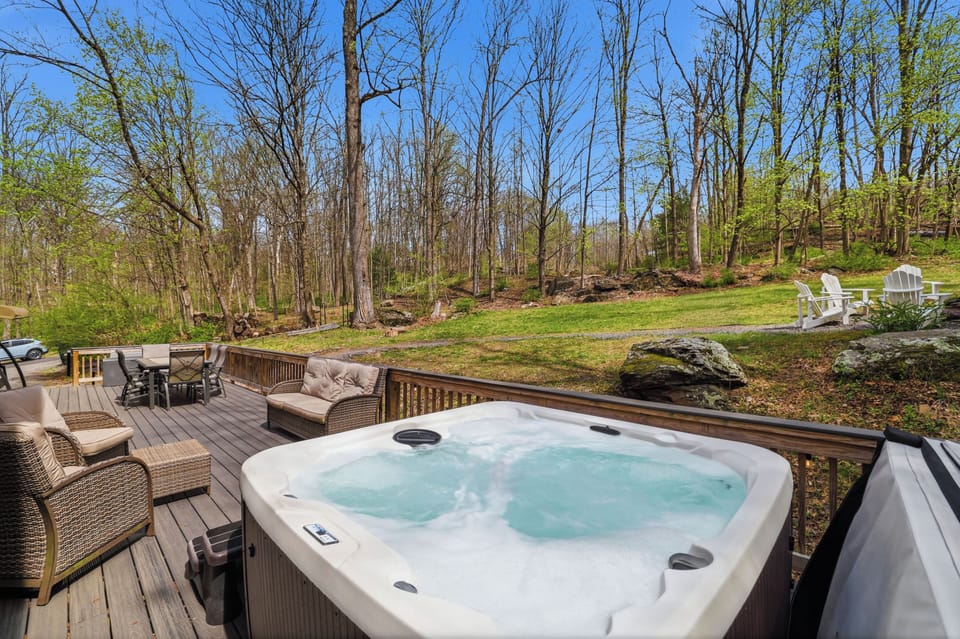Escape to nature with a private hot tub and comfortable  outdoor seating.