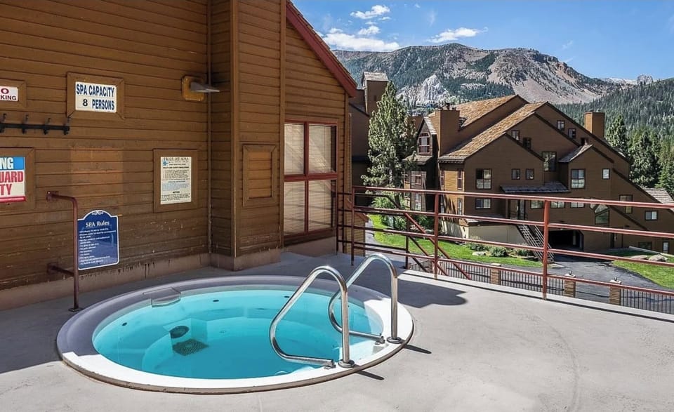 One of three mountain-view hot tubs under brilliant blue skies & sparkling stars