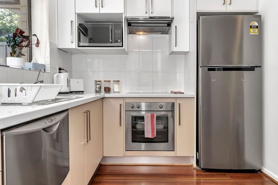 A chef-ready kitchen featuring a full-sized oven, microwave, and plenty of counter space for holiday cooking.