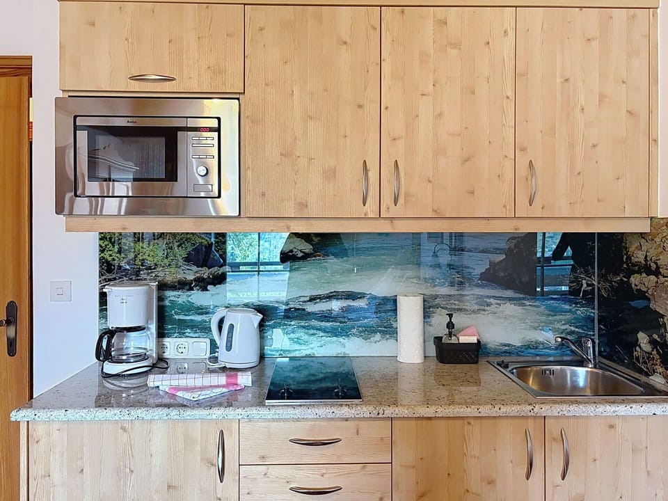 Kitchen, Countertop, Cabinetry, Flooring, Interior Design, Kitchen Appliance, Kitchen Sink, Drawer, Plumbing Fixture, Wood Stain