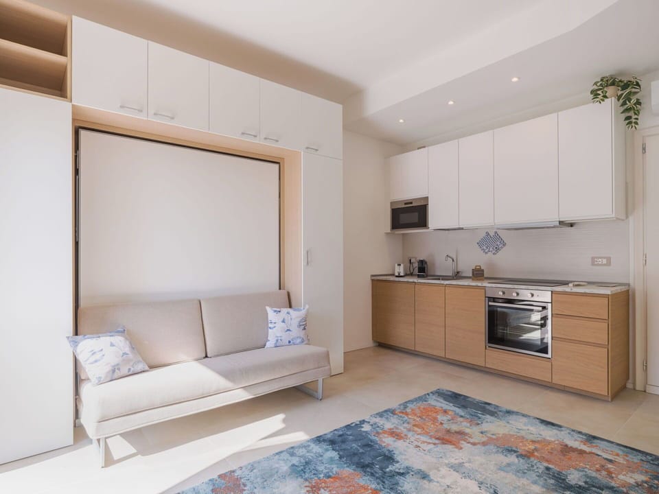 Furniture, Interior Design, Flooring, Wood, Floor, Couch, Room, Apartment, Wood Flooring, Living Room