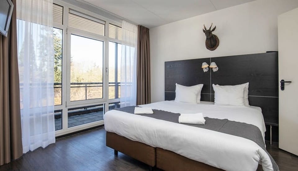 Unwind in crisp linens with sunlit balcony views.