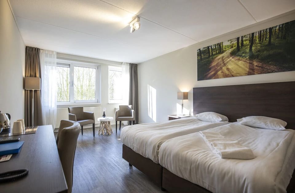 Settle in with a roomy layout, desk, and cozy chairs.