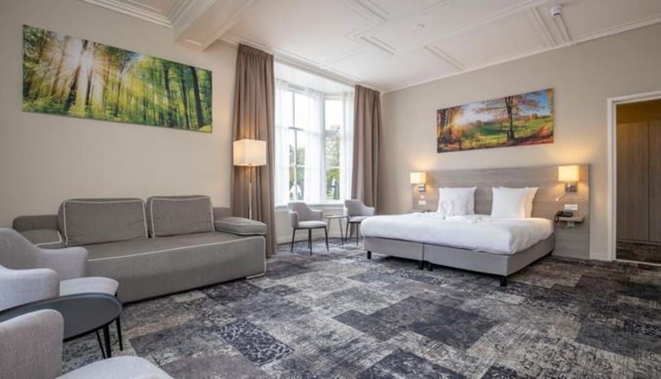 Lounge in a spacious suite with inviting seating and light