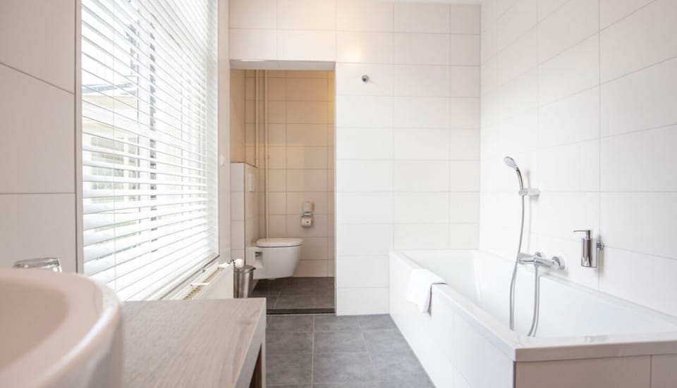 Unwind in a deep bathtub after a day exploring