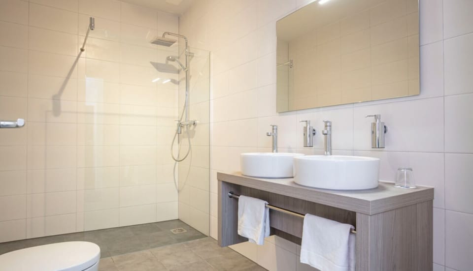 Start your day at a double vanity with a walk-in shower.